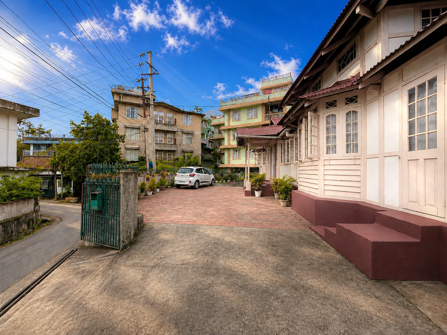 The arrival drive beside OOtO Homestay’s pink timber exterior.