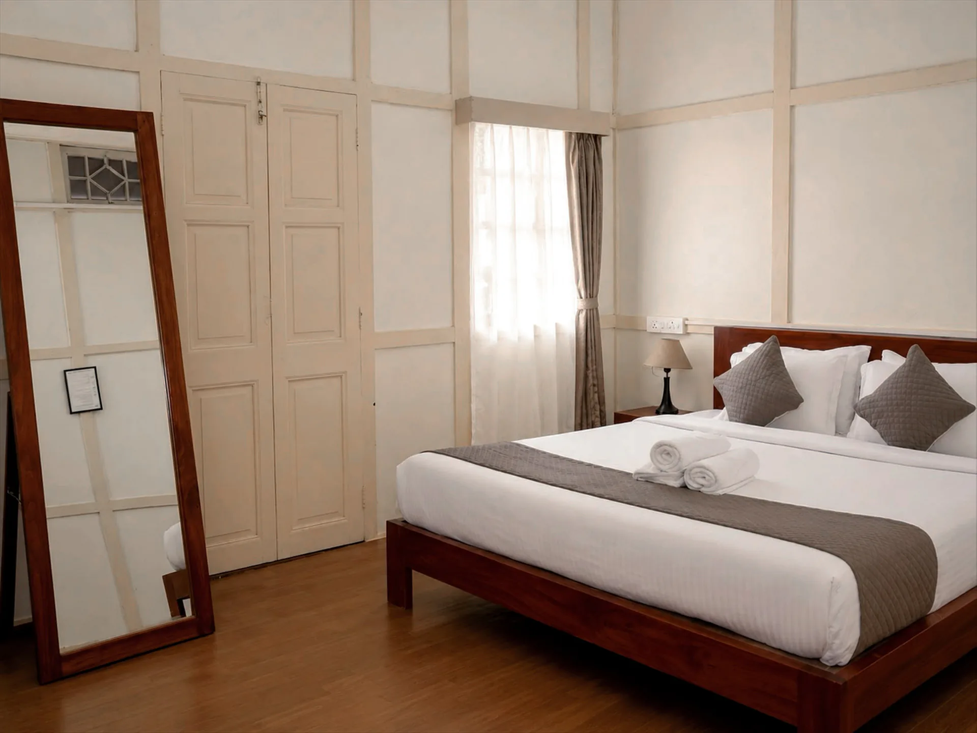 Hometown Glory’s king bed reflected in the room mirror.