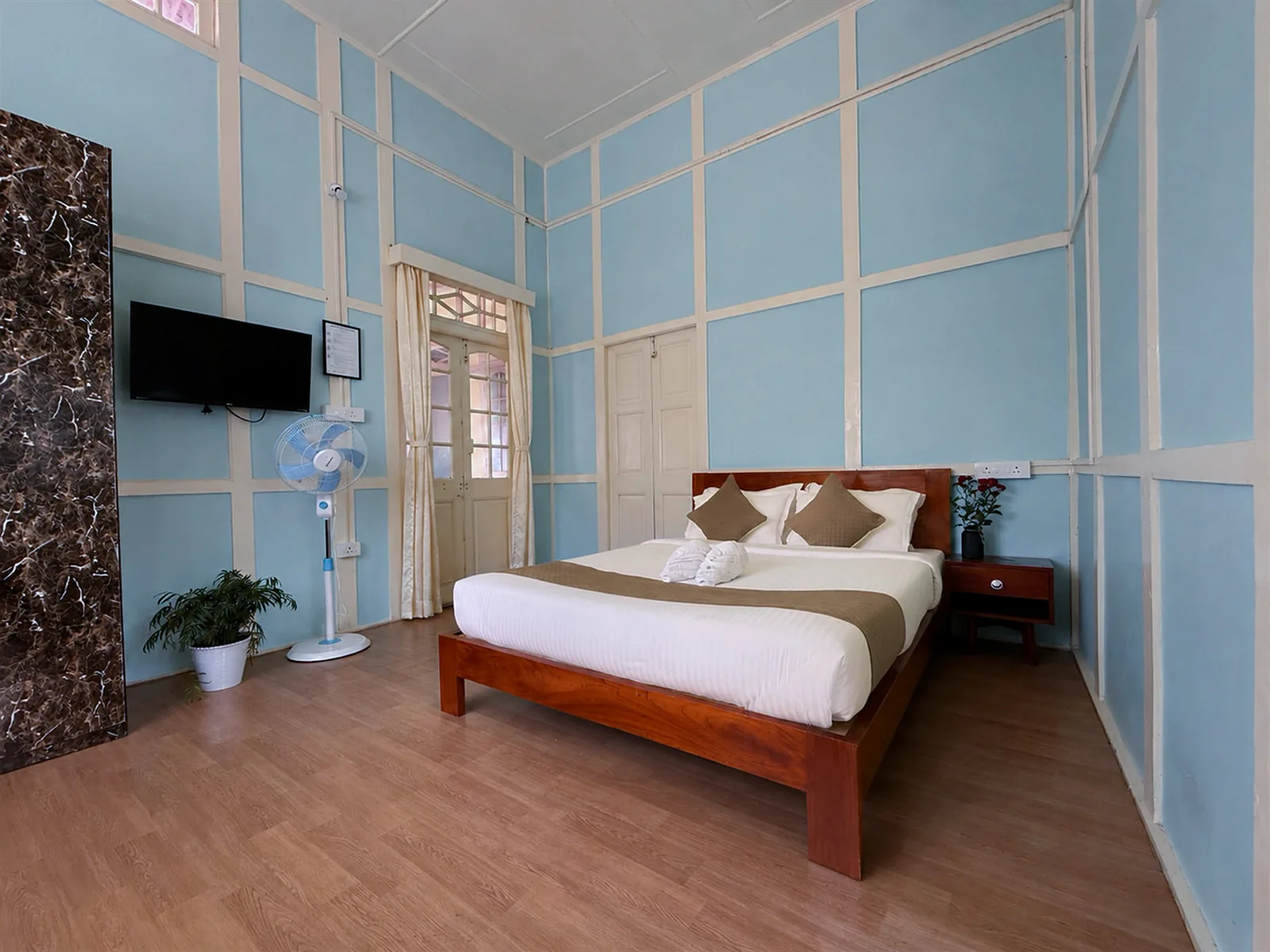 A wide view of Wild Blue’s timber bed and blue-panelled walls.