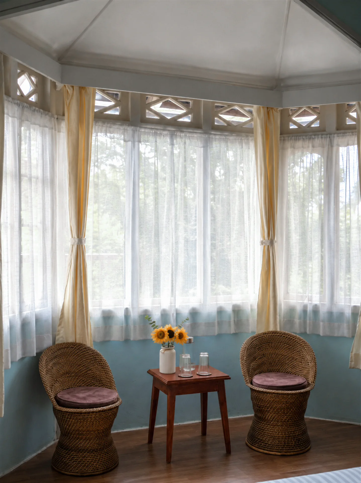 Wild Blue’s intimate bay-window seating beneath sheer curtains.