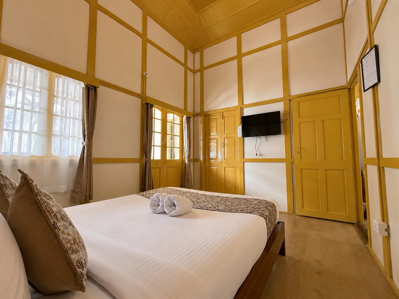 Yellow Haven’s bed beside a corner window.